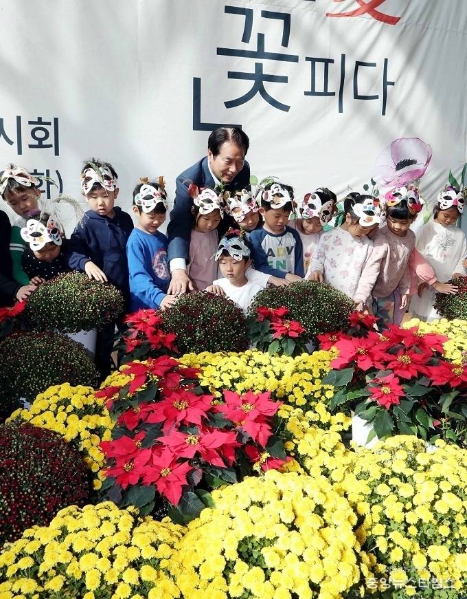 백군기 용인시장이 25일 용인시청 1층 화훼 전시장에서 어린이들과 기념사진을 찍고 있다. / 사진=용인시