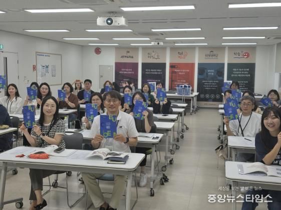 ‘부천시 평생학습사업 자료집’을 들고 찍은 단체기념 사진