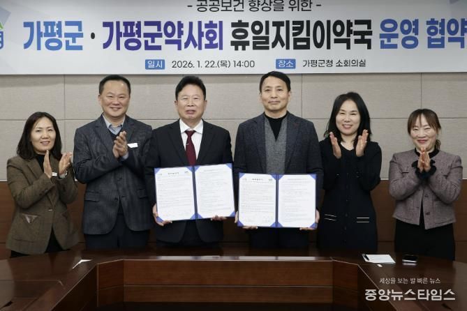 서태원 가평군수(사진 왼쪽에서 세번째)와 안병현 가평군약사회 회장(〃 네번째) 등이 22일 휴일지킴이약국 운영 협약식 후 협약서를 보이며 기념촬영을 하고 있다.(사진=가평군)